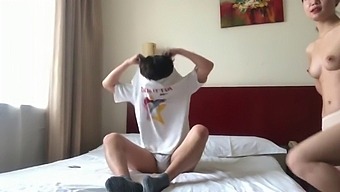 A Pair From China Engaging In Intimate Activities In A Hotel Room