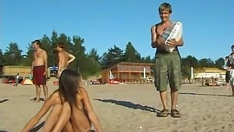 A Young And Stunning Girl Disrobes And Enjoys Herself On The Beach In The Open
